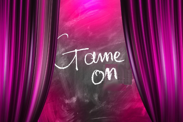 open curtains on a stage with the words "Game On" written in the opening