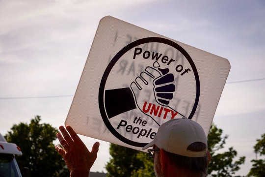 An activist at a Detroit, Michigan rally on June 14, 2018 (What damage are we doing to our children and ourselves?)