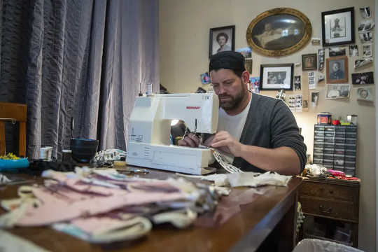 Tailor Derek Nye Lockwood sews face masks for hospitals on his dining room table in the Spanish Harlem neighbourhood of New York, April 22, 2020. 