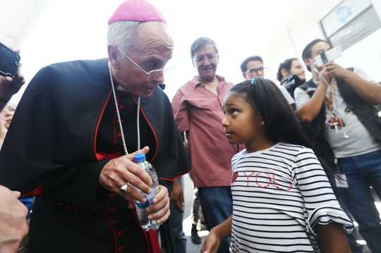 Why Catholic Priests Are Kneeling With Protesters