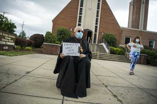 Why Catholic Priests Are Kneeling With Protesters