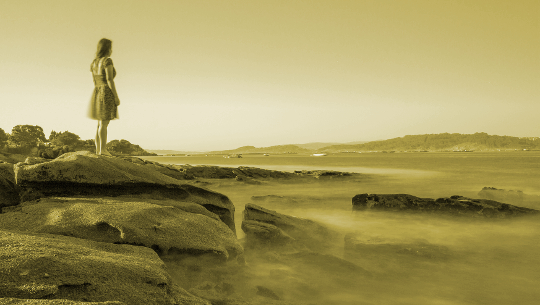 young girl looking over a desolate monochromatic landscape