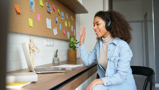 student having a conversation via her laptop