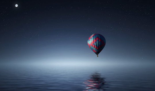 full moon over a hot air balloon