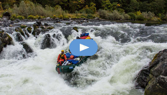 group of people riding the rapids in a raft