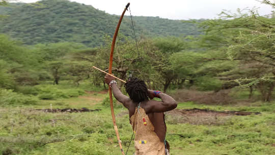 Hadzabe archer launching an arrow from his bow