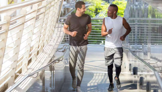 Two young men jogging in exercise clothes