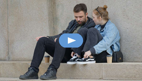 couple having a conversation sitting outside on steps