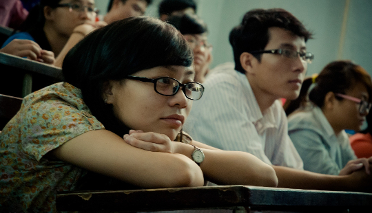 students in class paying attention to the teacher