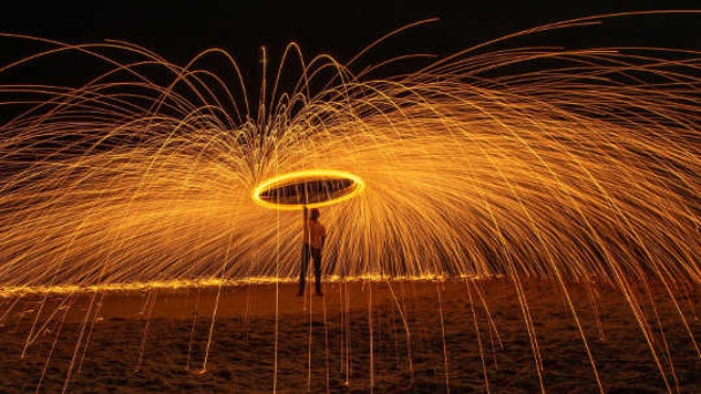 a person holding an umbrella under fireworks