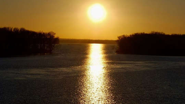 sunrise reflecting on calm waters