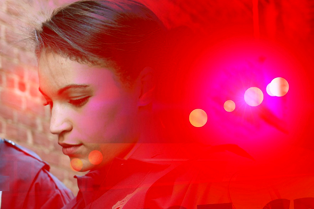 young woman with eyes closed surrounded by lights