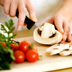 Photo of a person chopping vegetables.