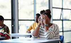 A stressed college student representing the challenge of time poverty in higher education.