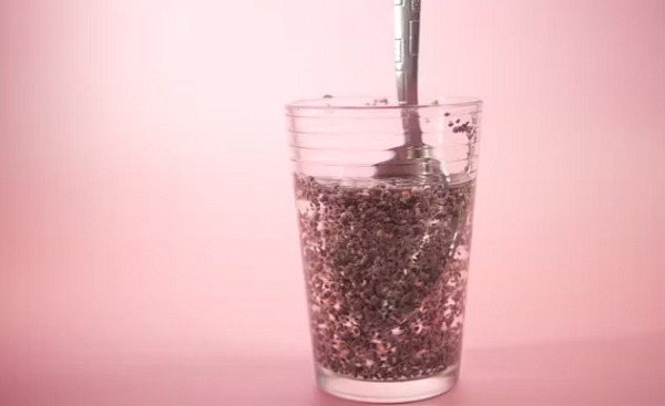 A glass of chia seed water with lemon slices, resembling the appearance of "tadpole water," highlighting its health benefits.