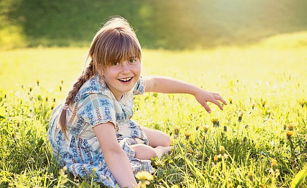 radiant young girl in an equally radiant meadow