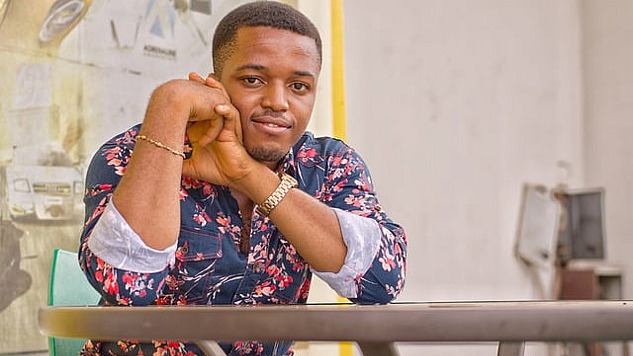 photo of a confident black man sitting at a table