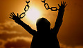 a person with hands up in the air with handcuff chain broken