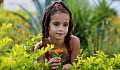 young girl in a field of plants and flowers