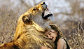 a young child hugging a lion who is roaring