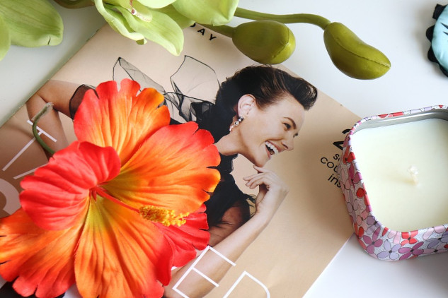 a girl behind a huge hibiscus flower