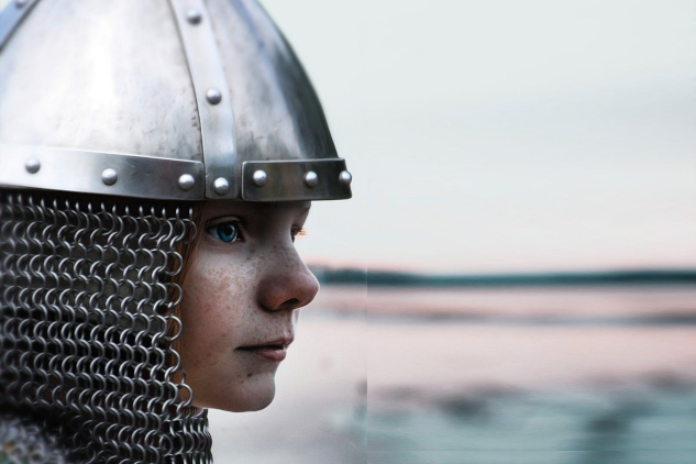 a female warrior with helmet and chain mail