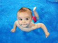 Person swimming underwater, emphasizing the importance of eye protection to prevent irritation and infection in chlorinated or saltwater environments.