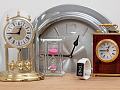 various clocks and watches all showing 15 minutes to 1