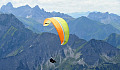 paraglider in the sky near a mountainous range